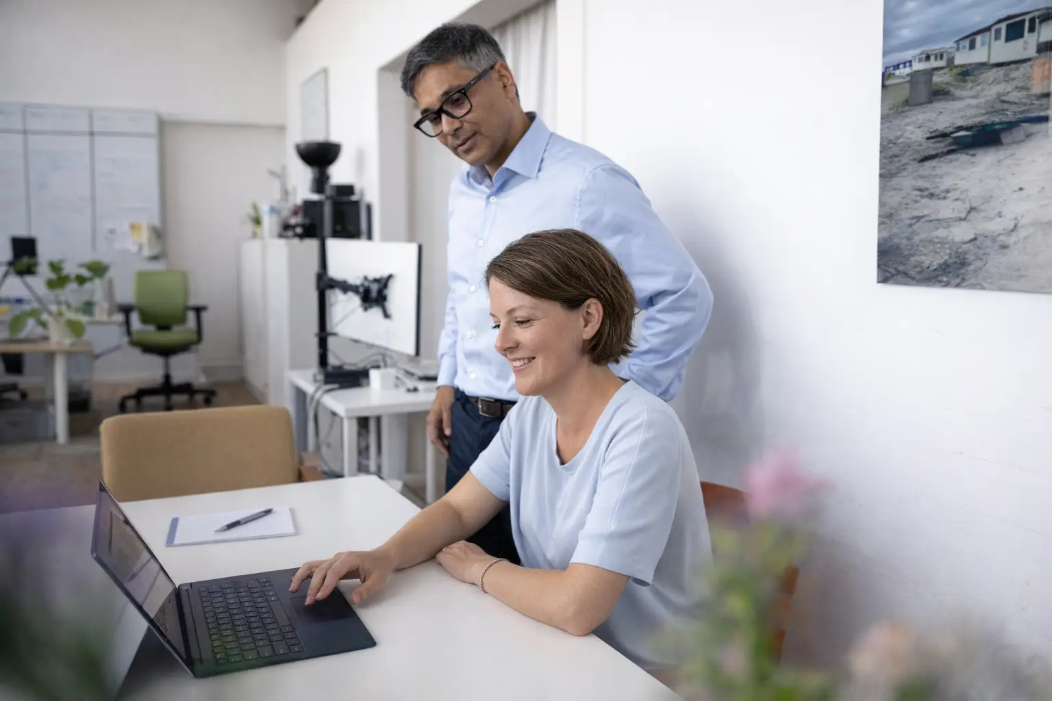 Een collega laat iets zien aan een andere collega